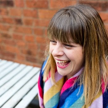 lady laughing outside on a cold day having her photo taken